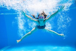 45903151 - little girl creates bubbles under water in the pool